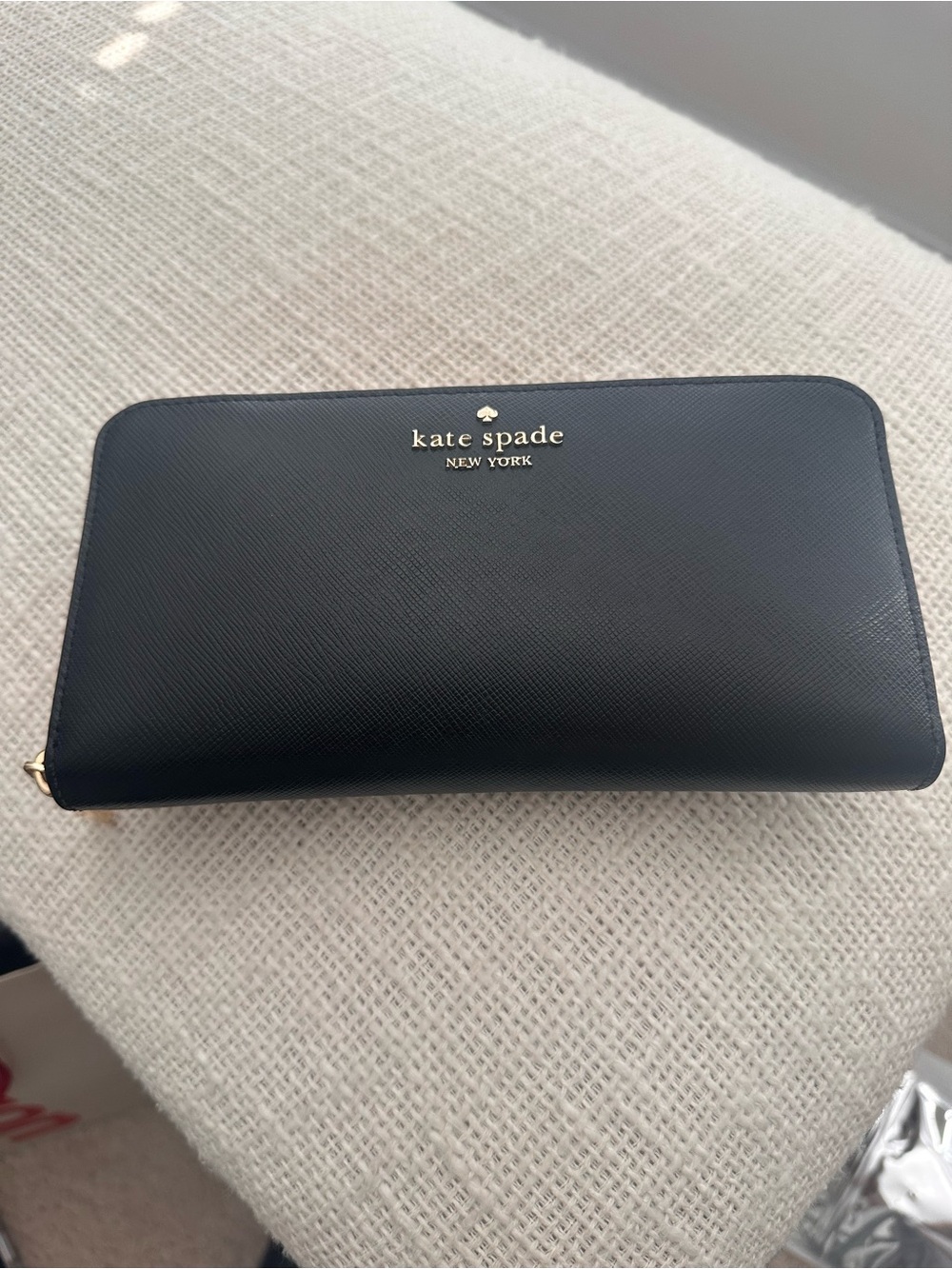 kate spade black Saffiano zip-around wallet with gold logo